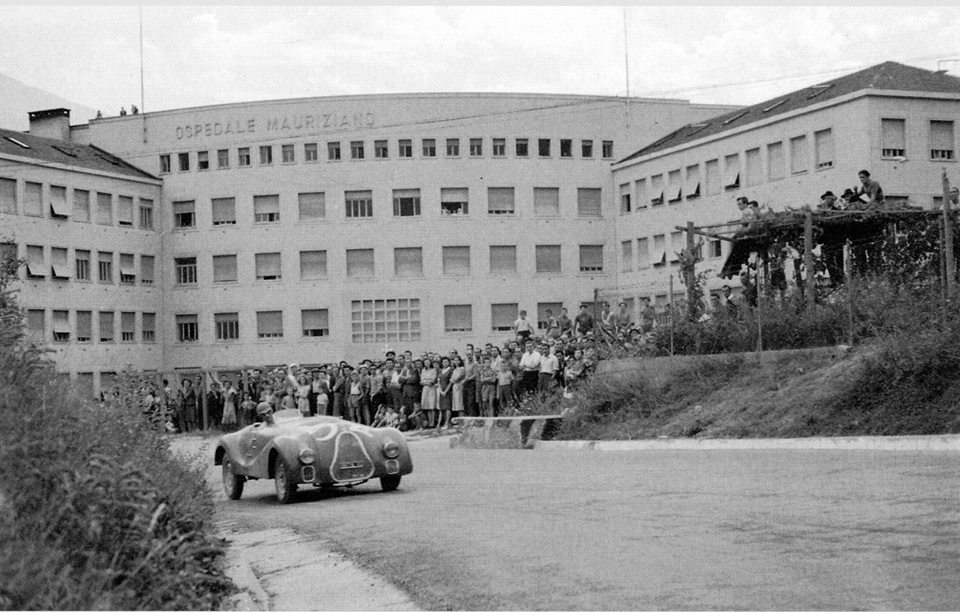 I bolidi dell'Aosta-GSB sfilano rombando davanti al nuovo, grandioso ospedale,1947 (foto concessa da Massimo Acerbi)